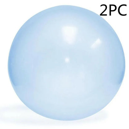 Large pink, yellow, green, and blue inflatable bouncy balls in various sizes for children's play.