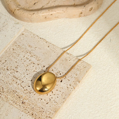 Gold-toned geometric pendant necklace on a chain, showing adjustable length between 41 cm and 50 cm.