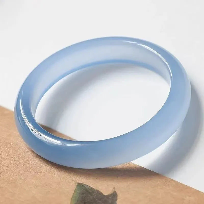 Natural agate wide tyre bracelet showing the stone's colour and the band's solid design on a wrist.
