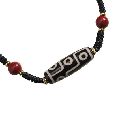 Men's adjustable agate dzi bead bracelet with traditional symbols on a shrinkable band.