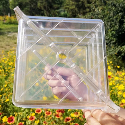 A square white plastic mould for growing square watermelons and fruit, measuring 13cm on each side.