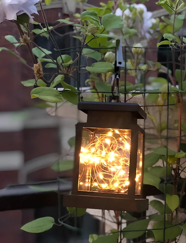 Black solar candle lamp with warm white LED illumination for outdoor gardens and patios