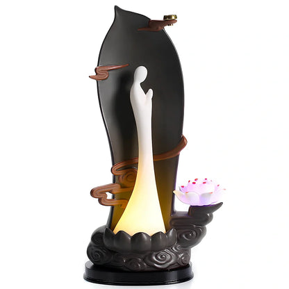 Purple sand tea pet backflow fragrance ornament with LED lighting creating cascading smoke effect