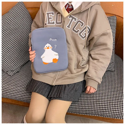 Blue tablet case with embroidered cartoon duck design showing zipper closure and cotton fabric texture