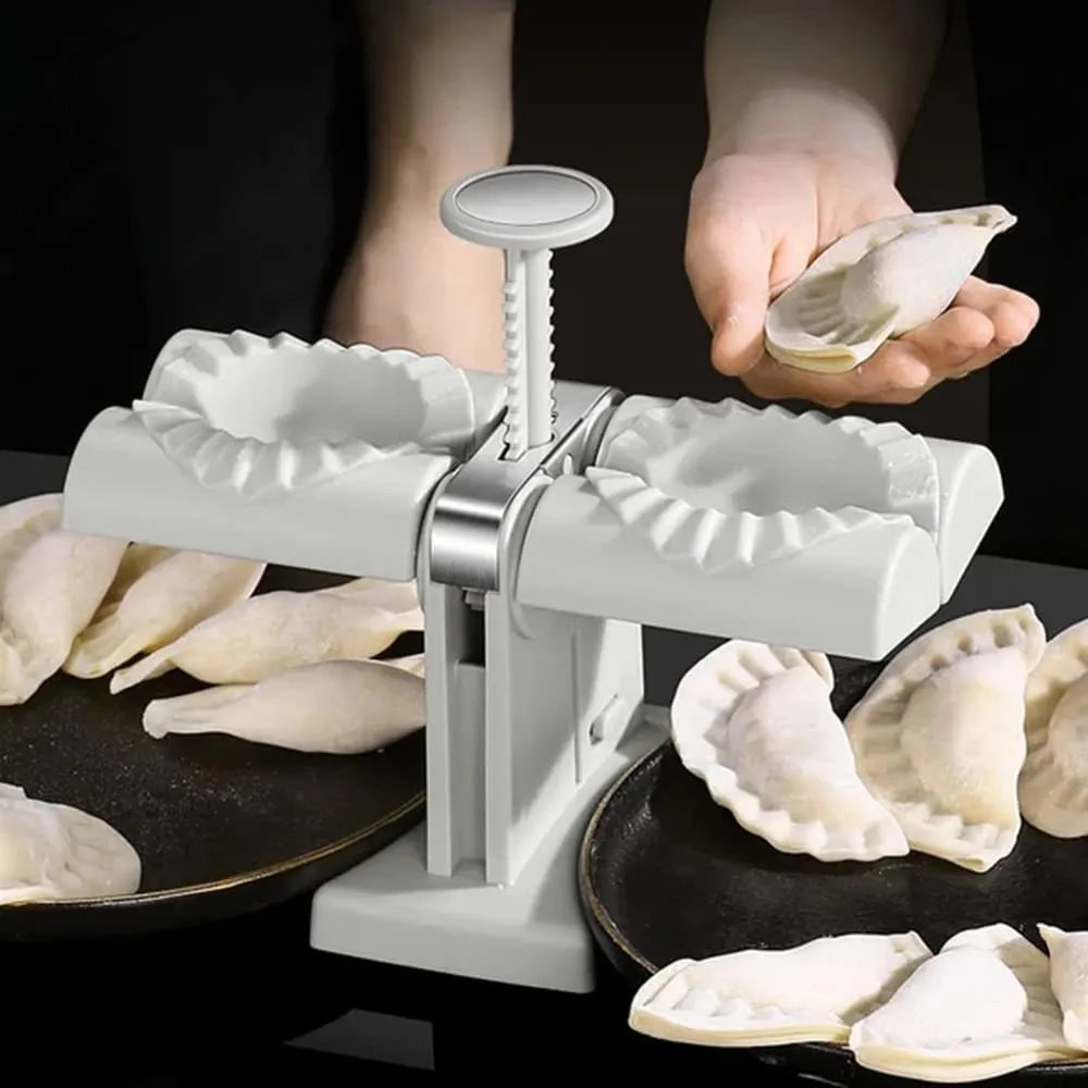 White double-head manual dumpling maker press on a kitchen counter