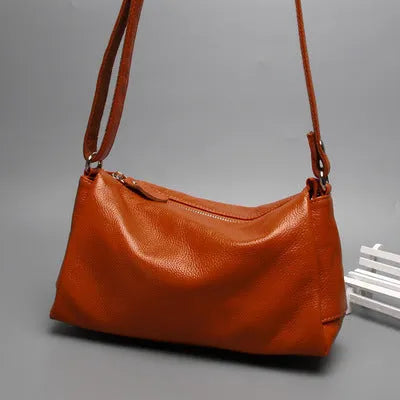 Soft genuine leather women's crossbody bag in horizontal square shape with single shoulder strap.