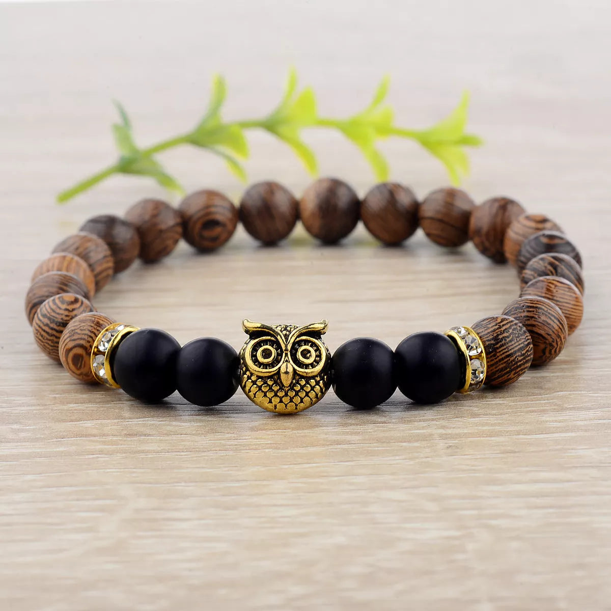 Owl frosted stone lifeline wood grain bracelet in black and gold, featuring wood beads and alloy stone
