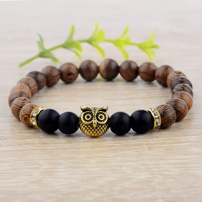 Owl frosted stone lifeline wood grain bracelet in black and gold, featuring wood beads and alloy stone