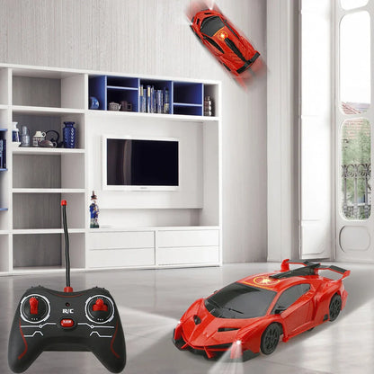 Red remote-controlled car climbing wall with industrial fan system and wireless controller