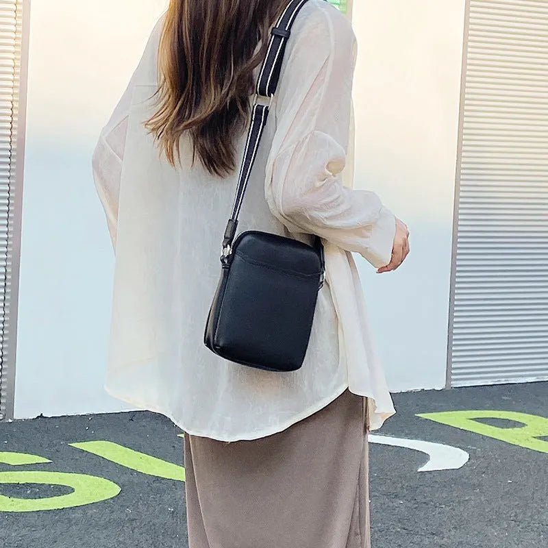 Solid colour mobile phone bag with adjustable strap showing 14.5x5.5x19cm dimensions and PU material construction