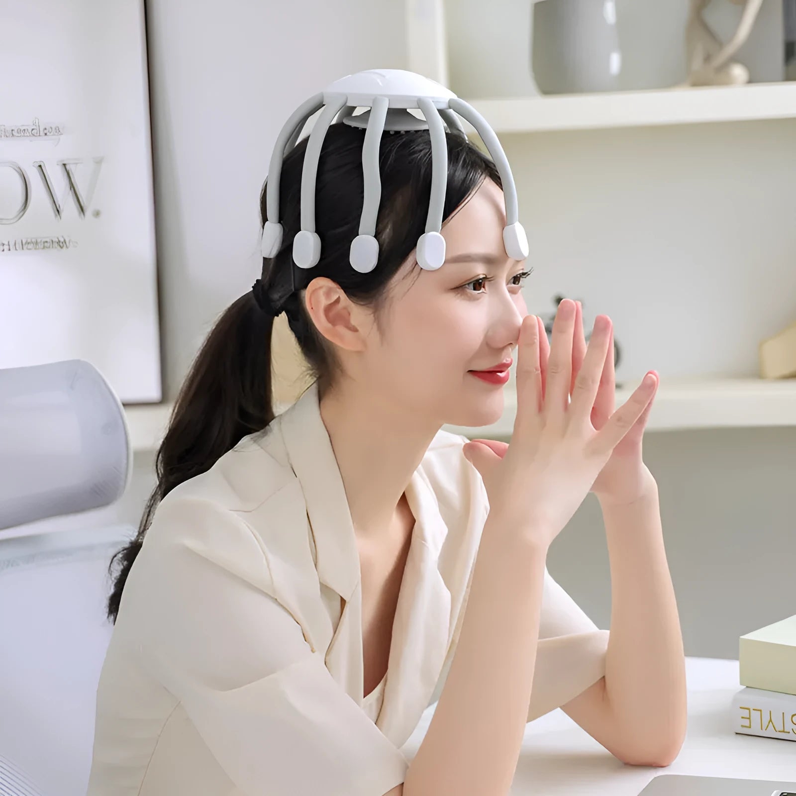 USB-powered handheld head massager with multiple flexible claws in black colour.