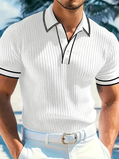 A man wearing a loose-fit, striped, short-sleeved polo shirt in a dark colour.