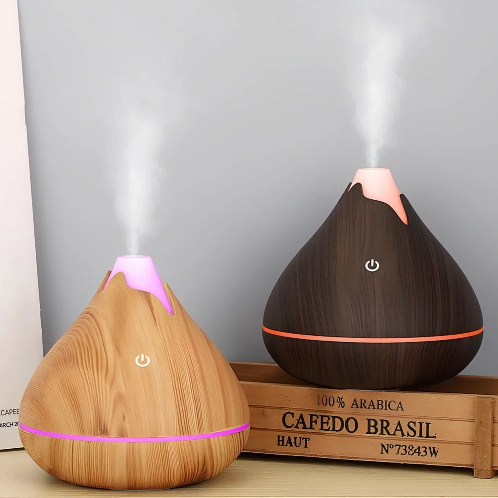 Round wood grain humidifier with USB cable and single mist outlet on light oak finish