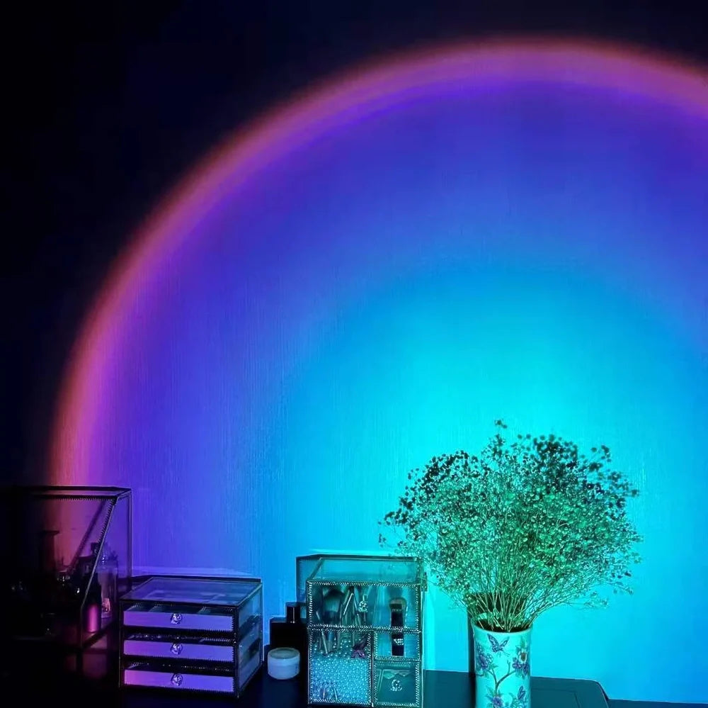 Rechargeable sunset projection lamp showing red and rainbow colours on wall