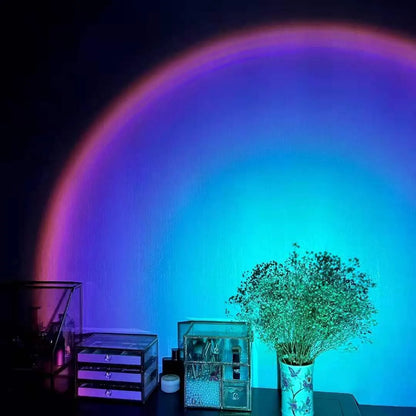 Rechargeable rainbow and sunset projection lamp with USB cable and push-button switch.