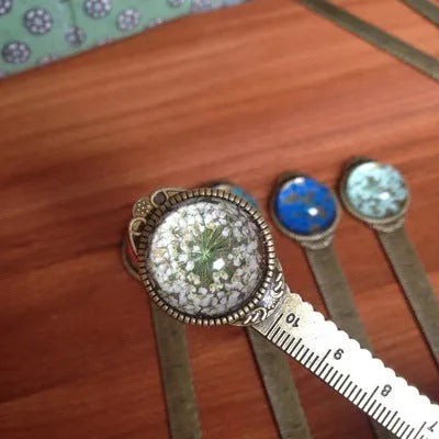 12cm handmade dried flower bookmark with gypsophila ruler featuring lace flowers, daffodils, and clover on blue background