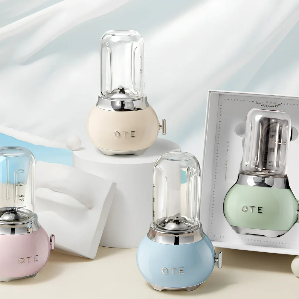 Small portable fruit juicer in blue with 400mL capacity cup and charging cable