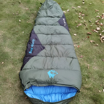 Outdoor mummy sleeping bag in army green with a compression sack, shown unrolled.