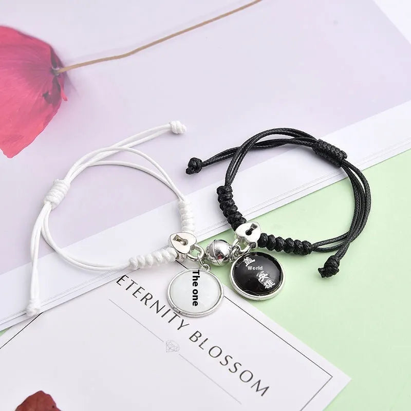 Magnetic suction couple bracelet pair in alloy with an electroplated finish, showing example designs like a crown and love lock.