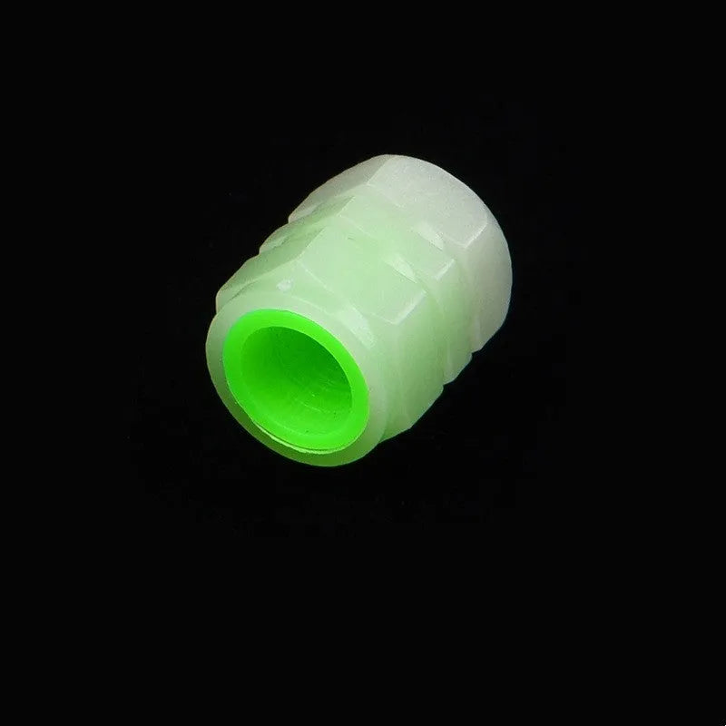 Set of four luminous rubber valve caps for car tyres showing glow effect