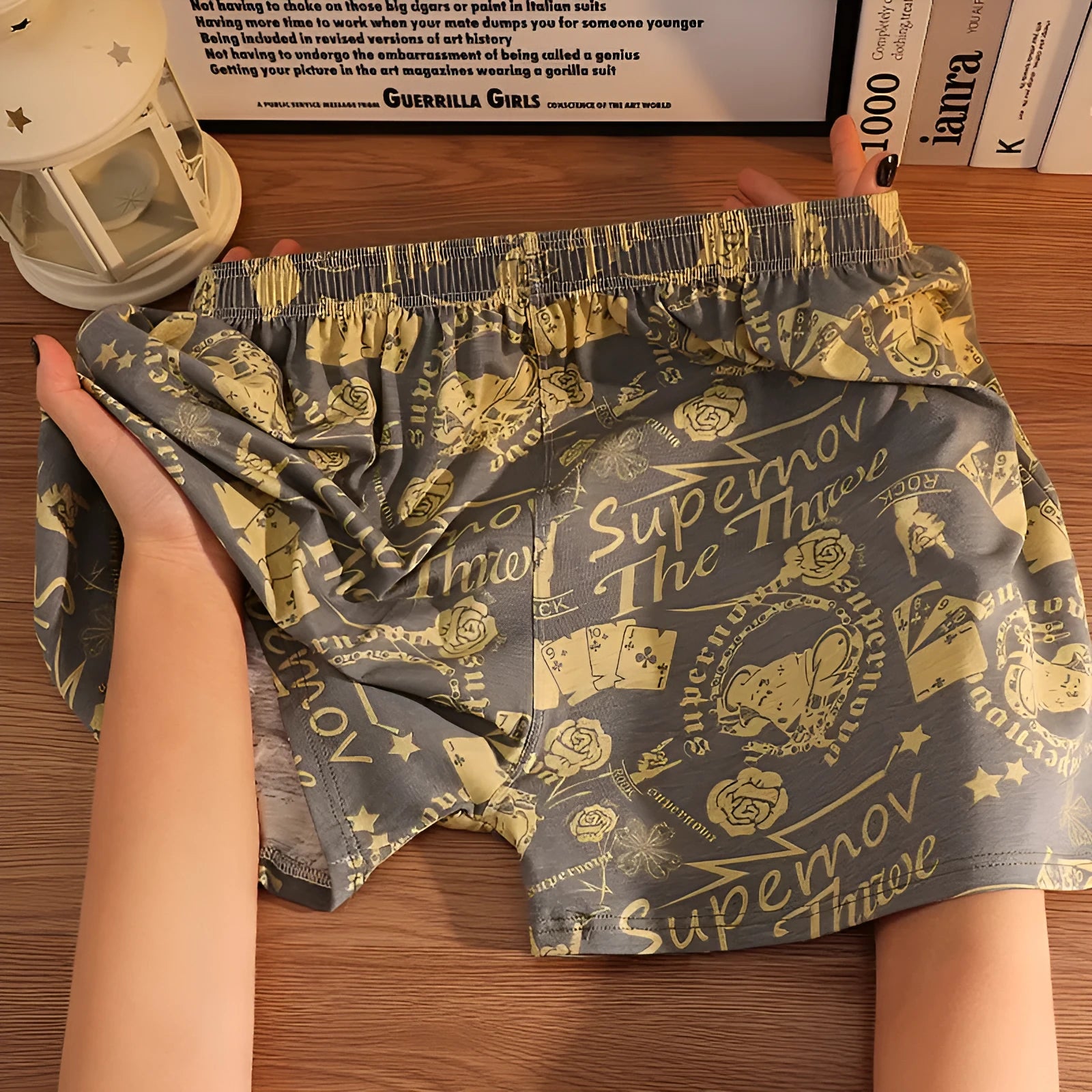 Men's grey printed cotton boxer shorts with mid waist and loose casual fit laid flat.
