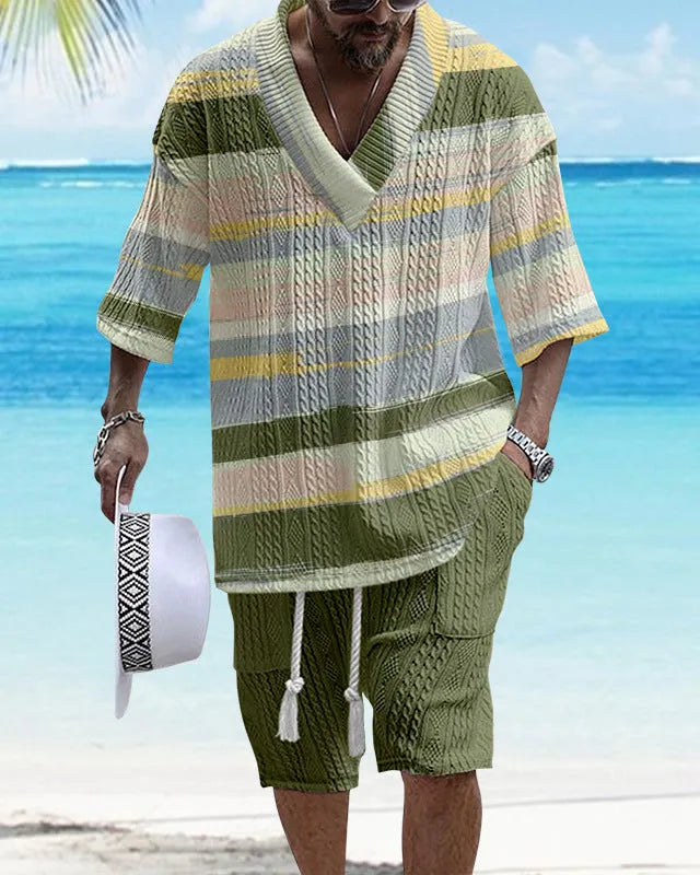Man wearing a loose blue short sleeve suit jacket and matching casual shorts.