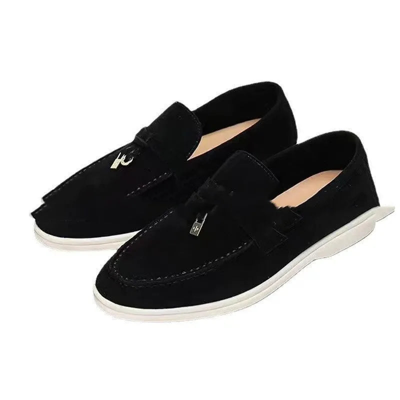 High top slip-on loafers in black with round toe and sewing line detail on a rubber sole.