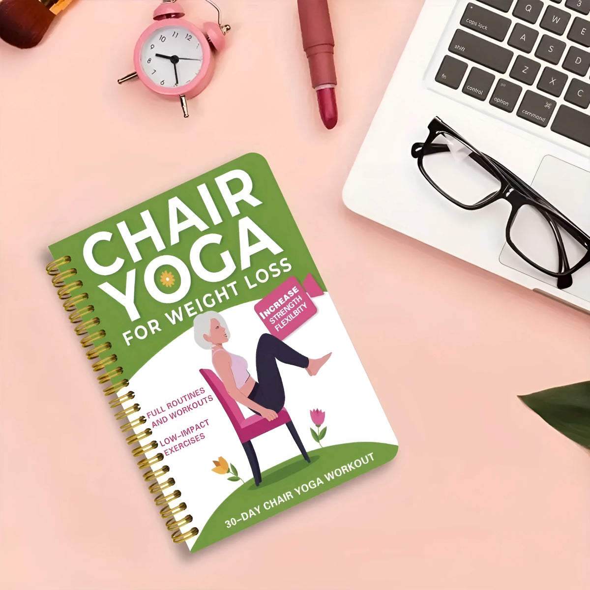 Green coil-bound 30 day chair yoga training notebook open to daily plan pages
