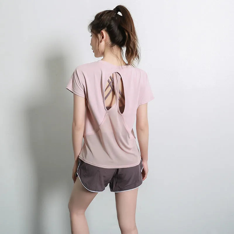 Women's pink short sleeve polyester sports T-shirt for fitness and running.