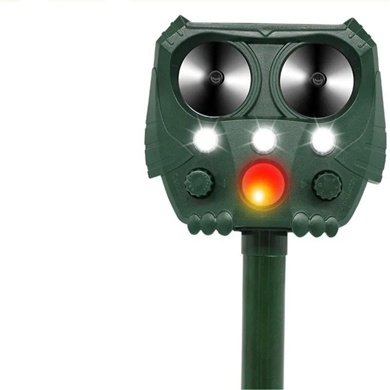 Green solar-powered ultrasonic dog and pest repeller unit for outdoor garden protection