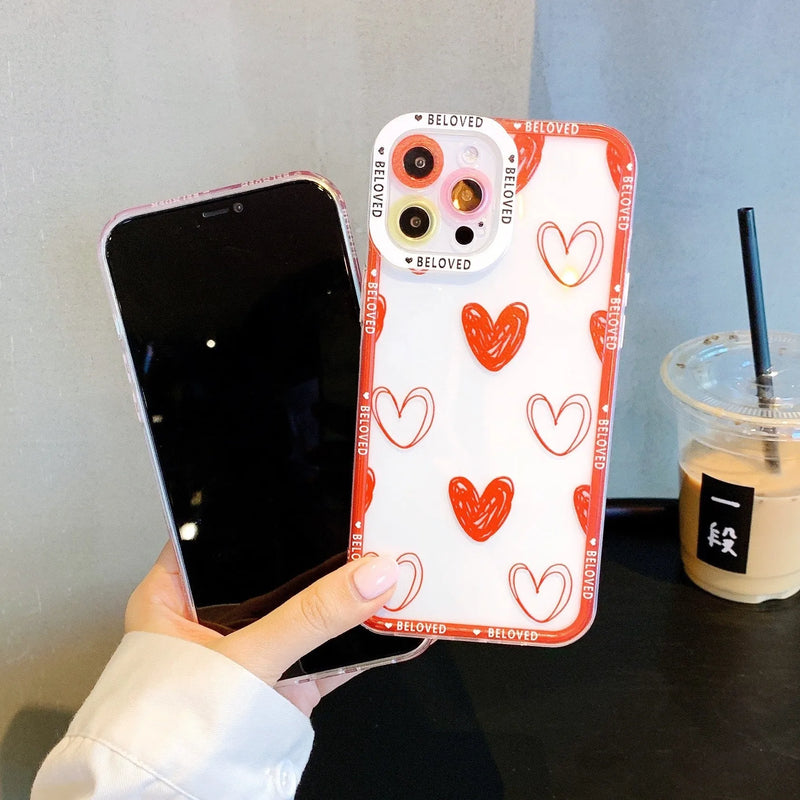 Phone case for iPhone models featuring a pink love heart or graffiti red love heart angel eyes design, manufactured from TPU material as a back cover style protective case compatible with multiple Apple smartphones