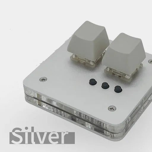 Mini white plastic USB wired keyboard with multimedia keys on a desk.