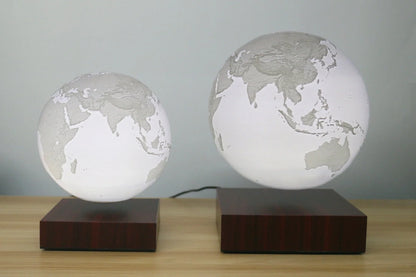 Levitating Earth or Jupiter lamp floating above base with LED illumination