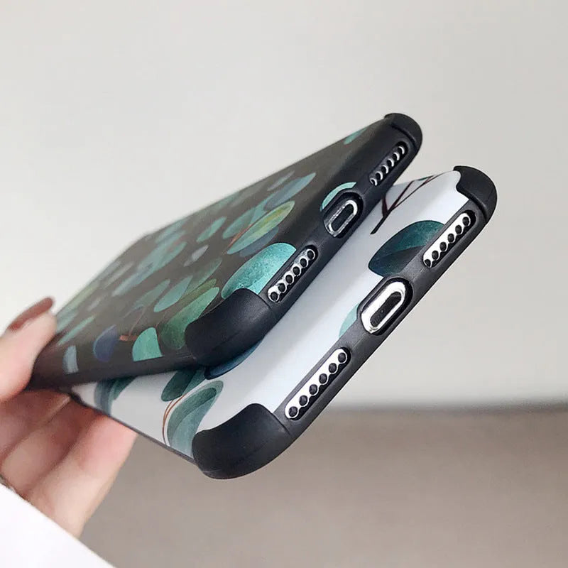 Black silicone iPhone case with a leaf pattern design on the back.