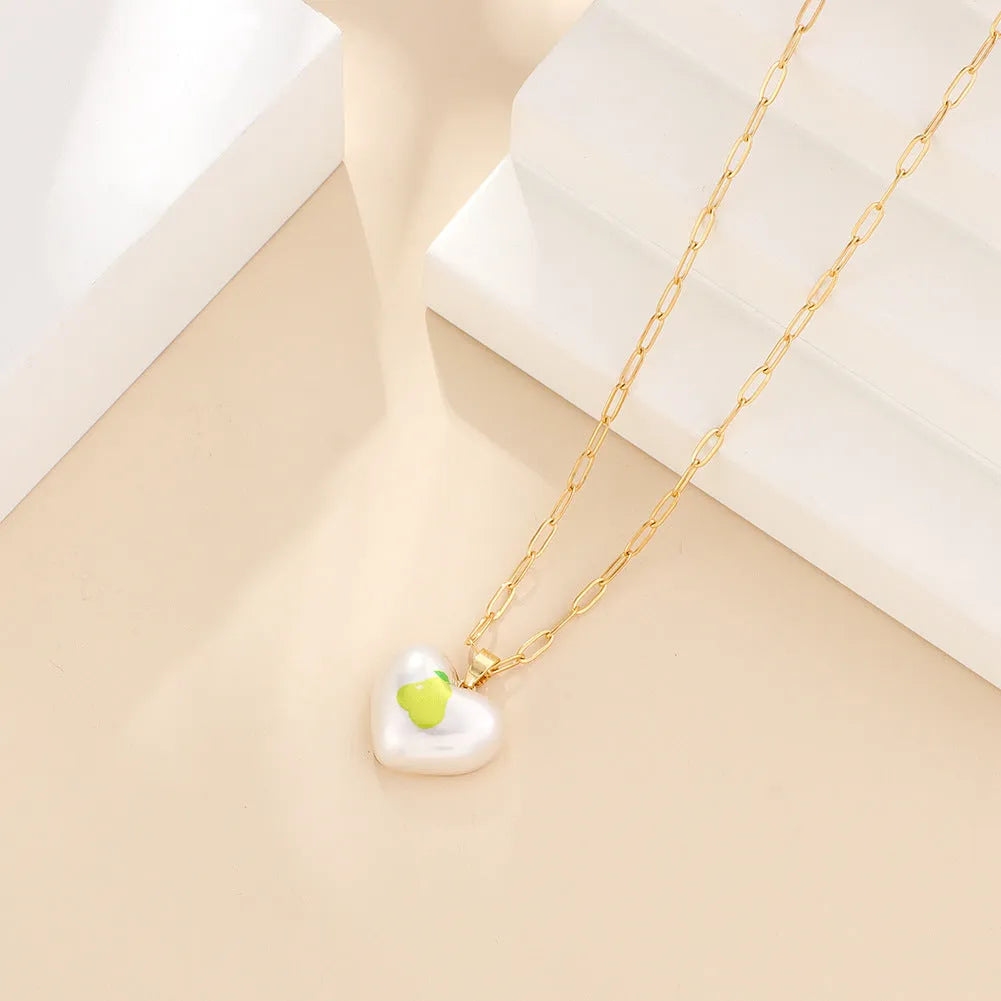 Geometric heart-shaped fruit pendant necklace on an adjustable metal chain