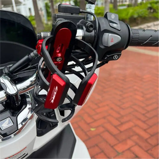 Modified water bottle cage mounted on Honda X-ADV scooter bumper in black, titanium, gold, red, blue, or green colour