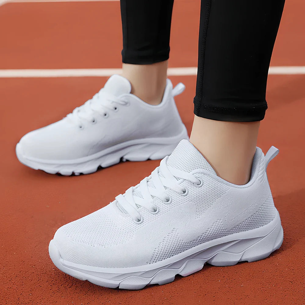 Women's black sneakers with mesh upper, wedge heel, and lace-up front