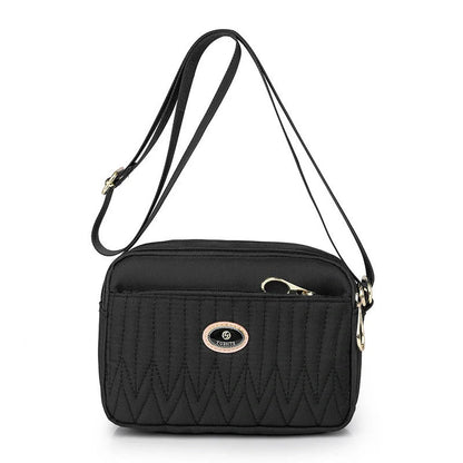 Casual women's crossbody messenger bag in nylon with polyester lining, available in multiple colors