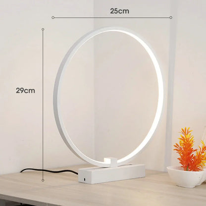 White circular LED bedside lamp with 25cm diameter on iron base showing warm white illumination