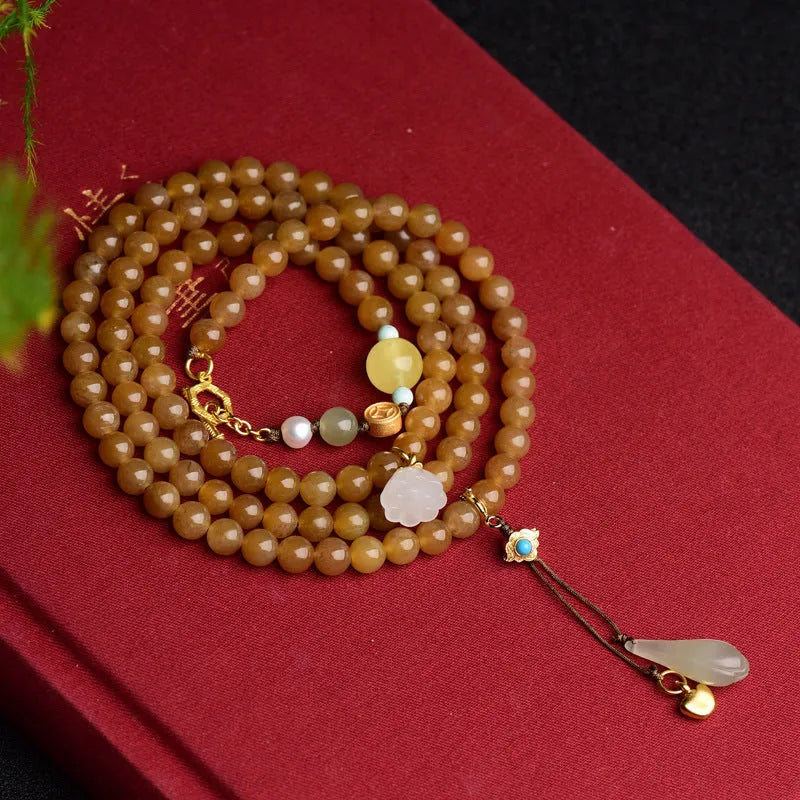 Women's bracelet with green pine beads, beeswax elements, leaf shapes, and sequin accents