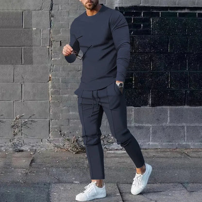 Men's light grey polyester two-piece suit set with long sleeve round neck T-shirt and matching trousers.
