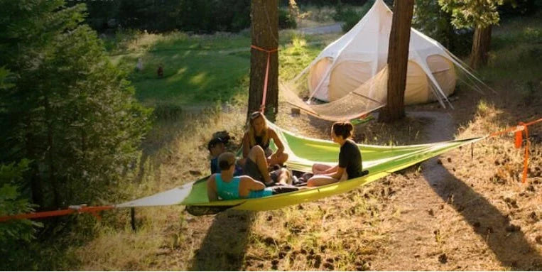 Spacious multi-person hammock with 3-point suspension system, ideal for outdoor adventures and backyard relaxation.