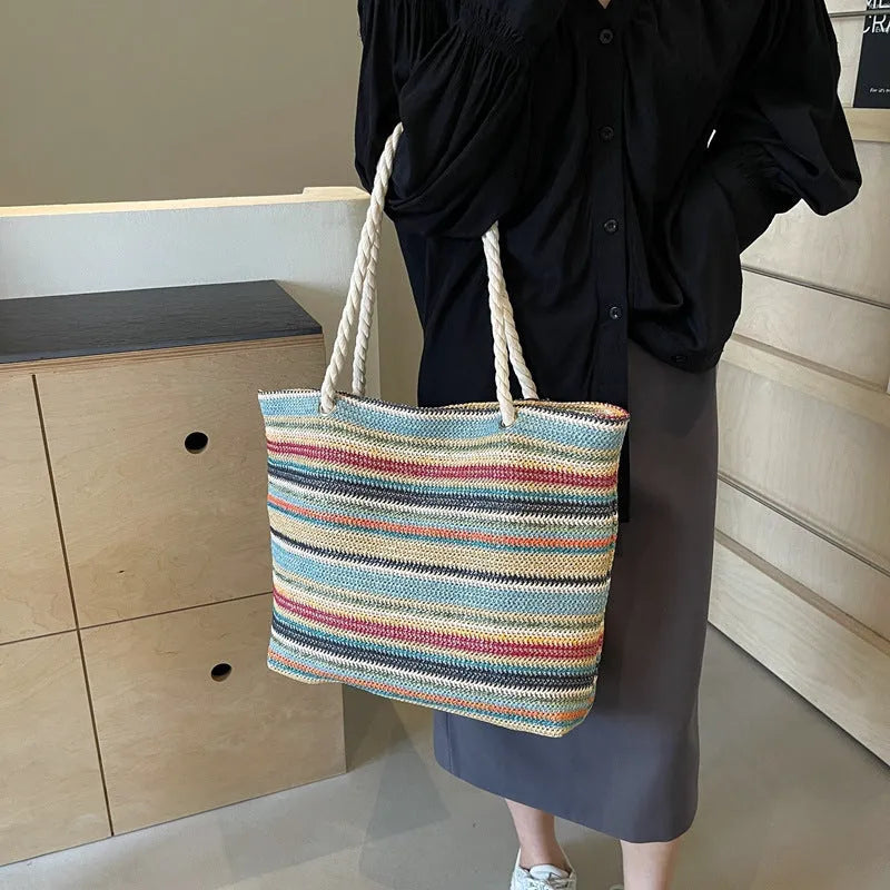 Blue straw-woven nylon shoulder bag with a single strap and large compartment.