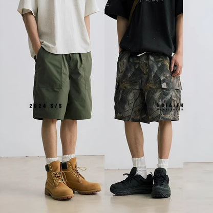Loose straight-leg denim shorts for teenagers in army green, showing elastic waistband and zip fly.