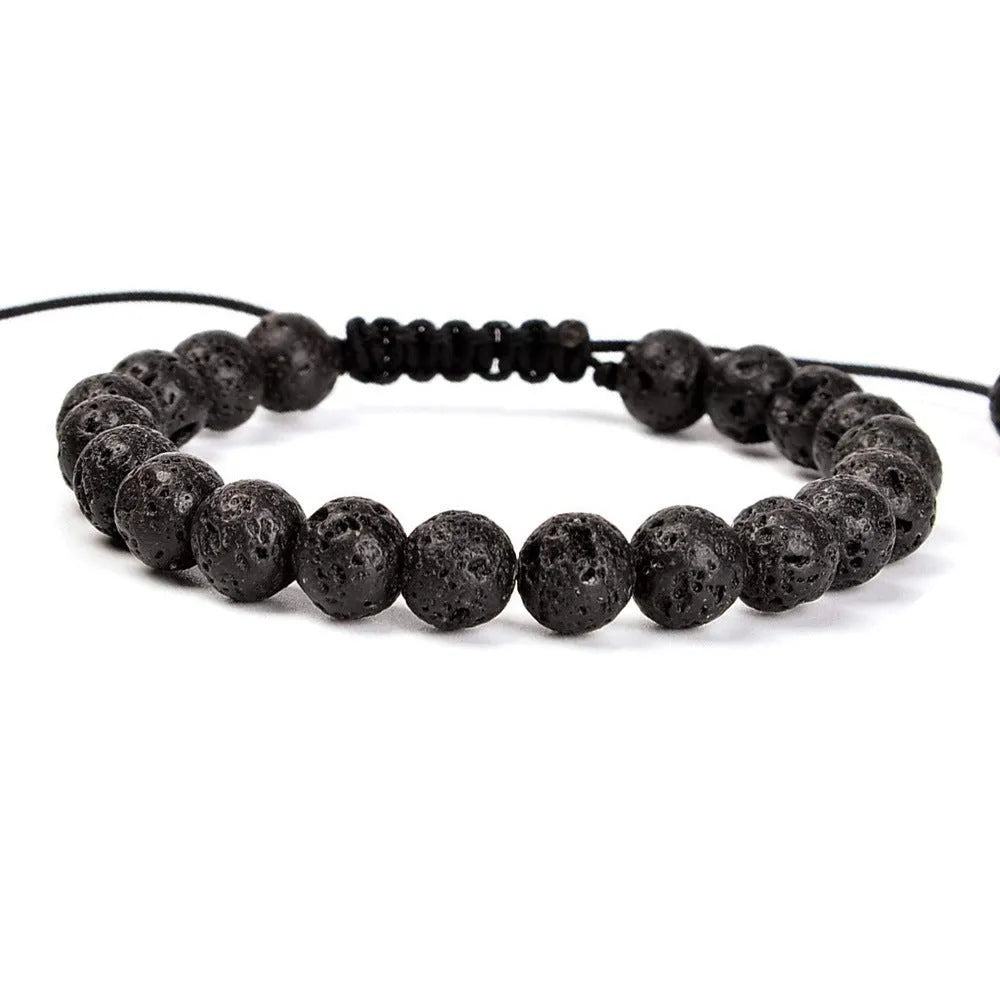Close-up of a women's flat knot braided healing bracelet hand-woven with colourful gemstones.