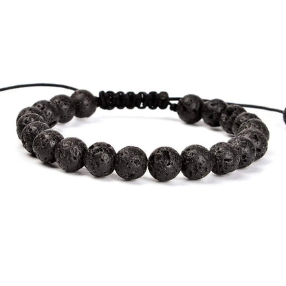 Close-up of a women's flat knot braided healing bracelet hand-woven with colourful gemstones.