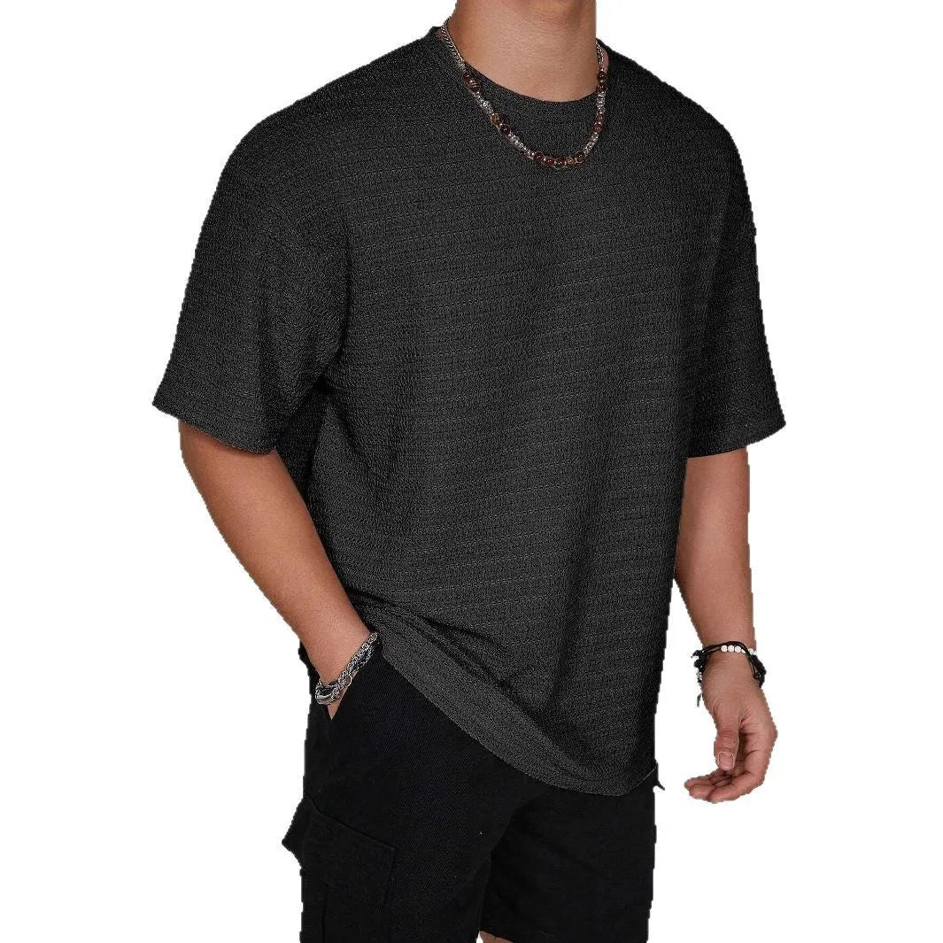 Men's slim-fit solid colour short sleeve T-shirt on a hanger, showing lightweight fabric.