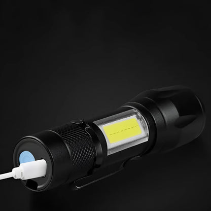 Black USB rechargeable LED flashlight with 10W output and aluminium alloy body, pocket-sized torch for hiking and camping.