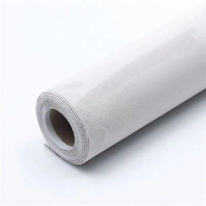 Rolls of self-adhesive leather suede in multiple colours showing texture and adhesive backing.