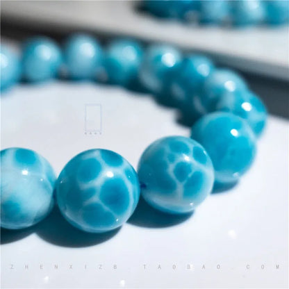 Blue bodhi bracelet with pearl accents showing bead sizes from 6mm to 14mm in Maillard style design